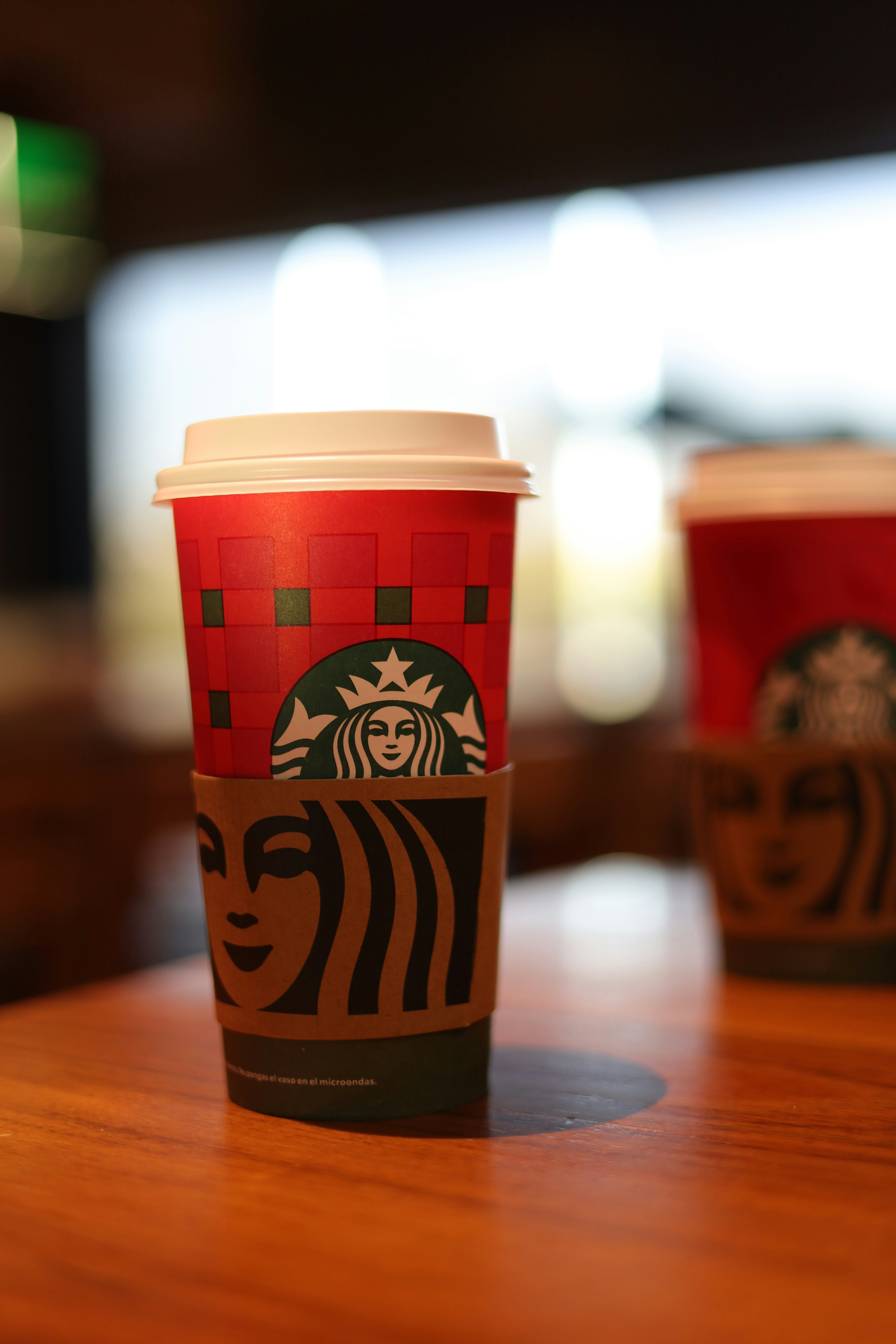 Starbucks holiday cup on a wooden table