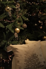 Christmas tree with golden ornaments and pillows