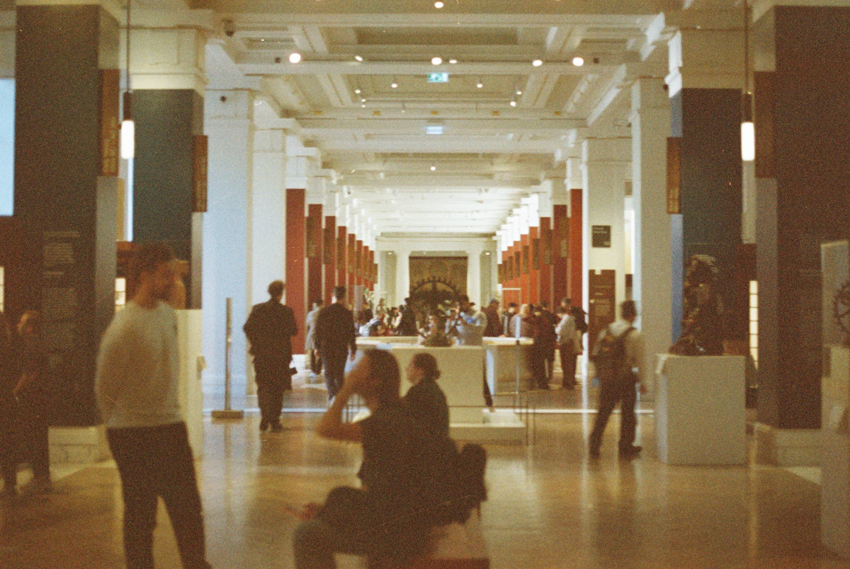 Visitors walking through a grand museum hall