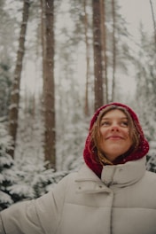 Young woman smiling in a snowy forest