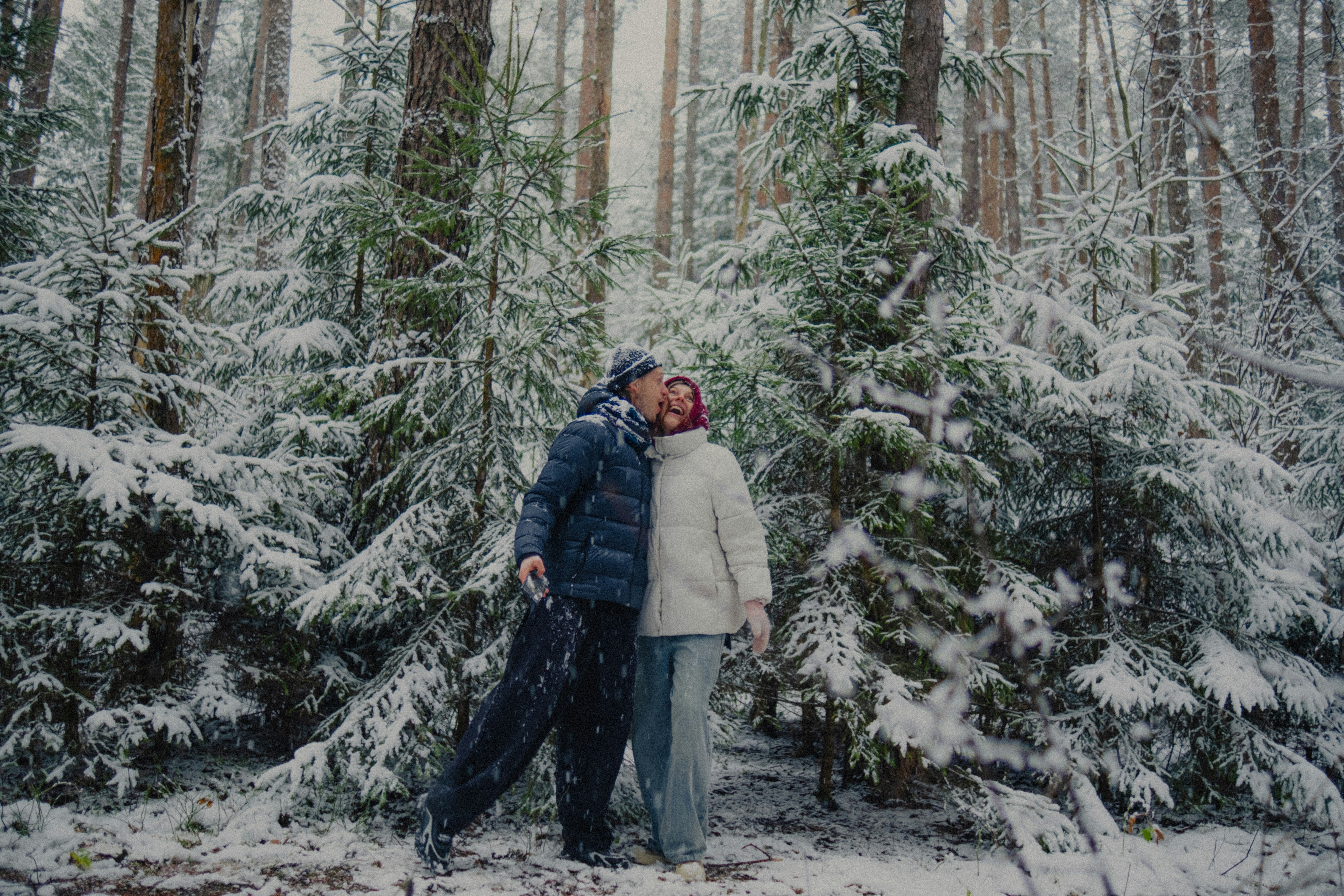 Couple embracing in a snowy forest