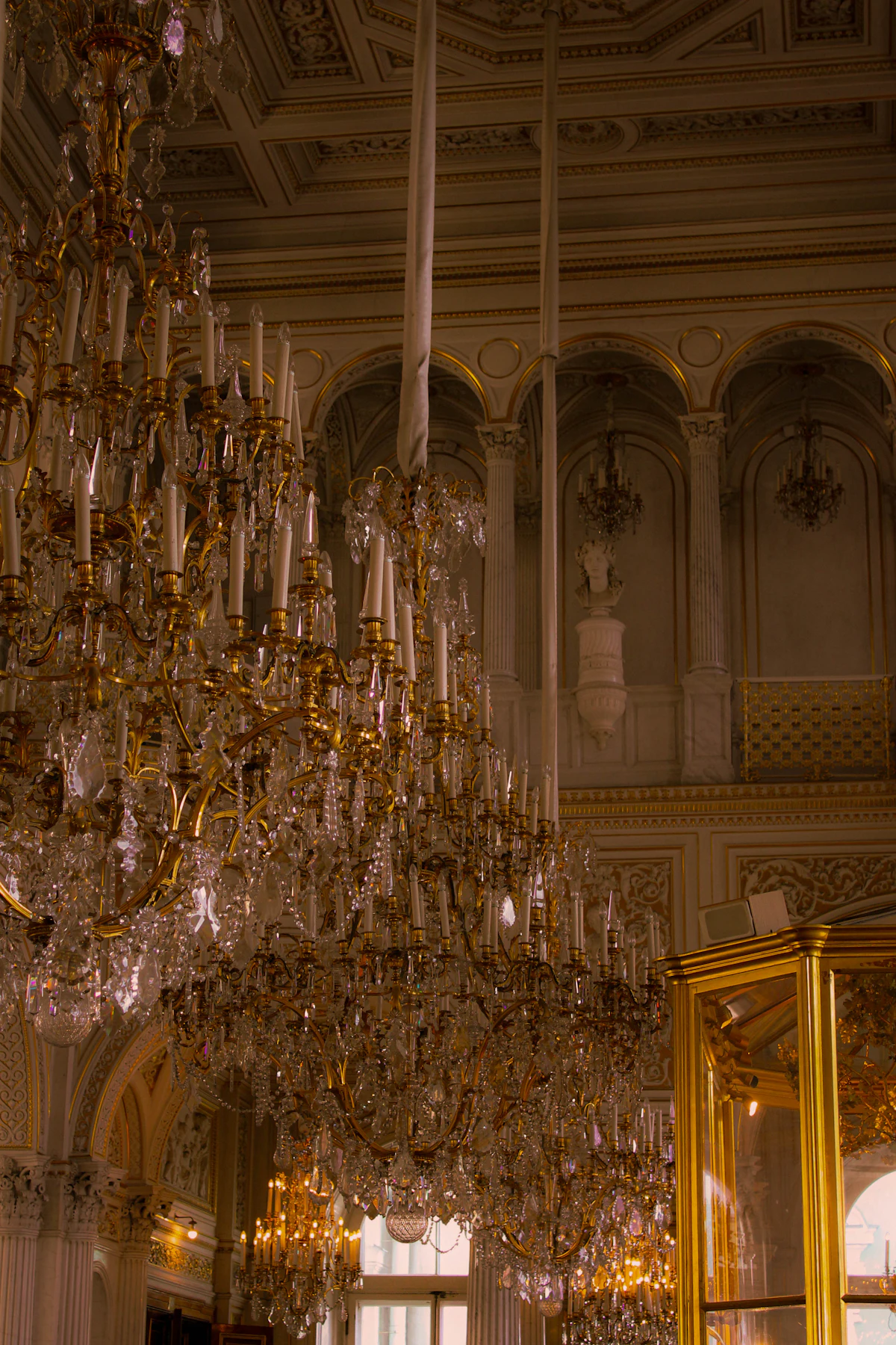 Ornate hall under gilt chandeliers. Illustrative editorial image, not a photograph of Barcaldine Castle.