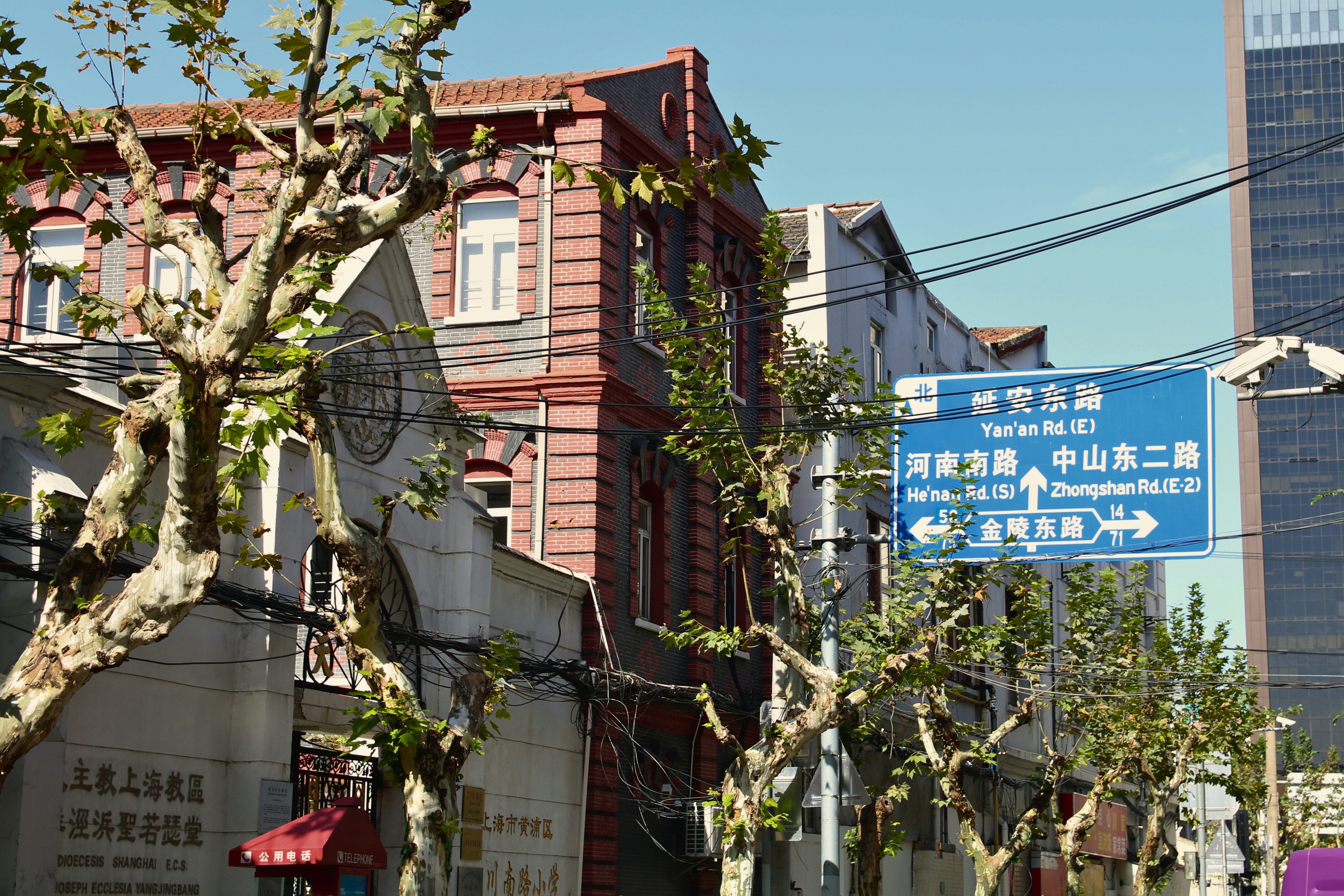 Street sign with chinese characters and arrows.