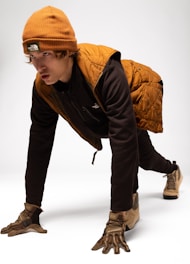 Young man in winter gear on white background