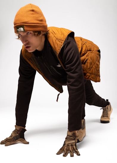 Young man in winter gear on white background