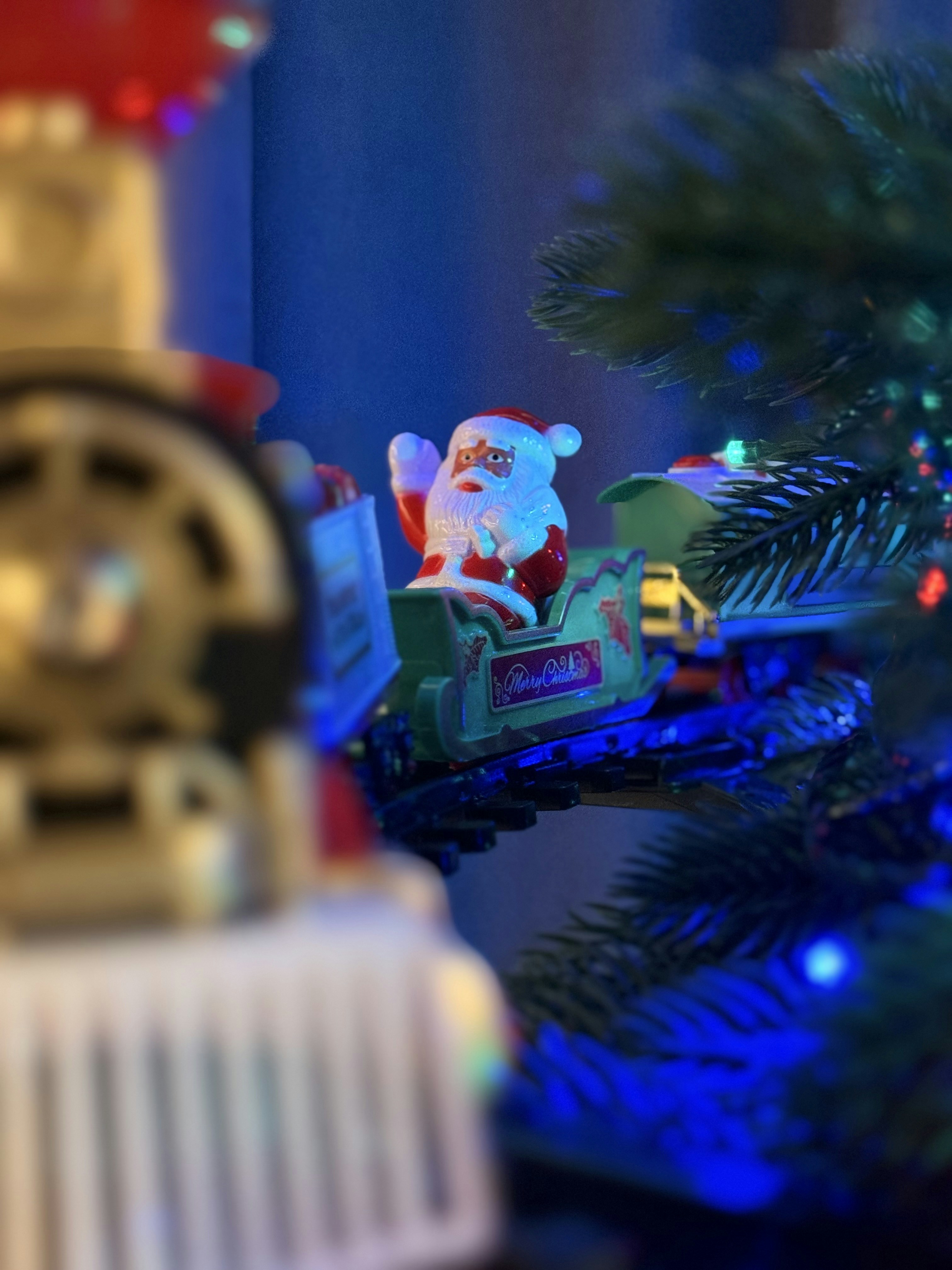 Santa on a toy train hanging on christmas tree