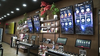 Retail store display with products and screens.