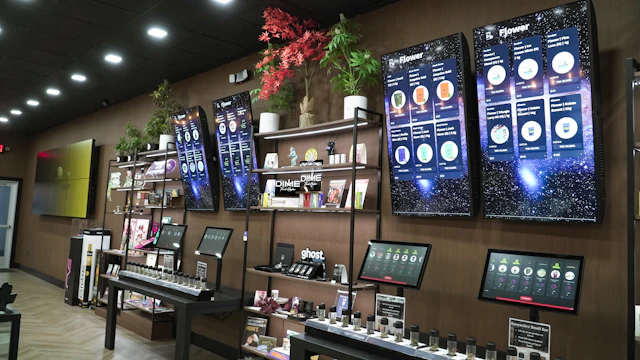 Retail store display with products and screens.