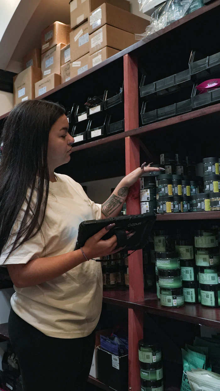 Warehouse staff member checking inventory with a tablet