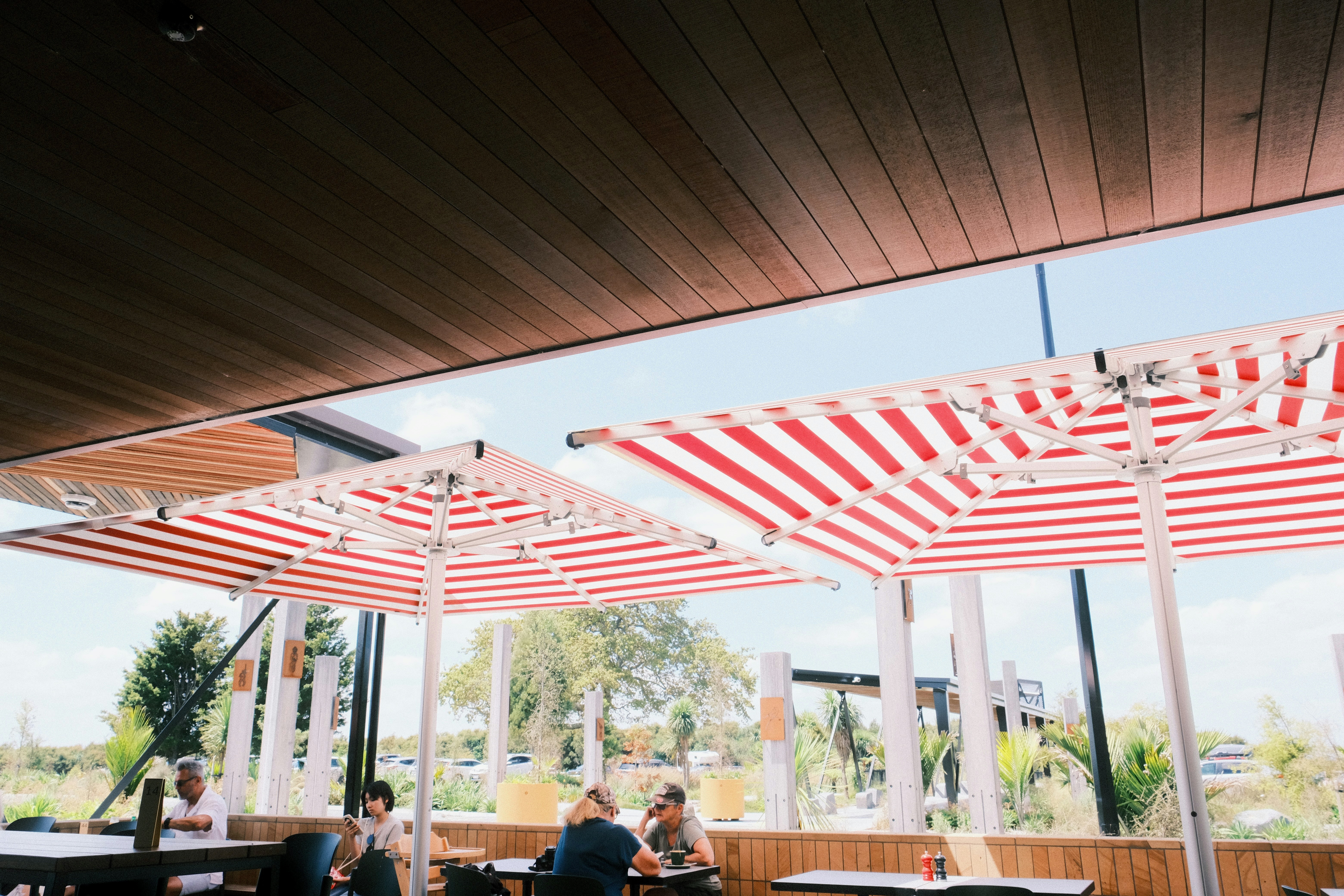 Outdoor seating with red and white striped umbrellas