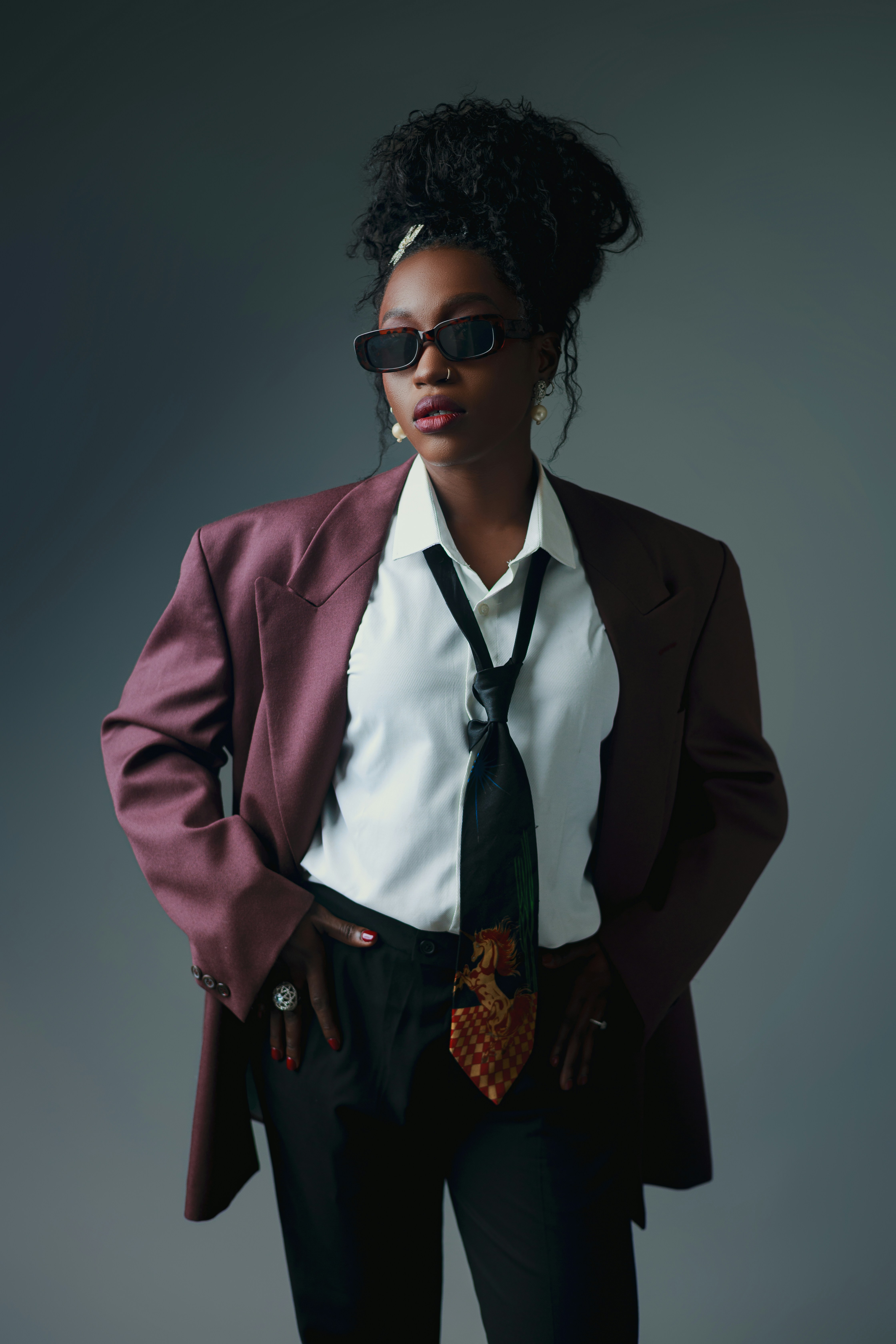 Woman in a suit with sunglasses and tie