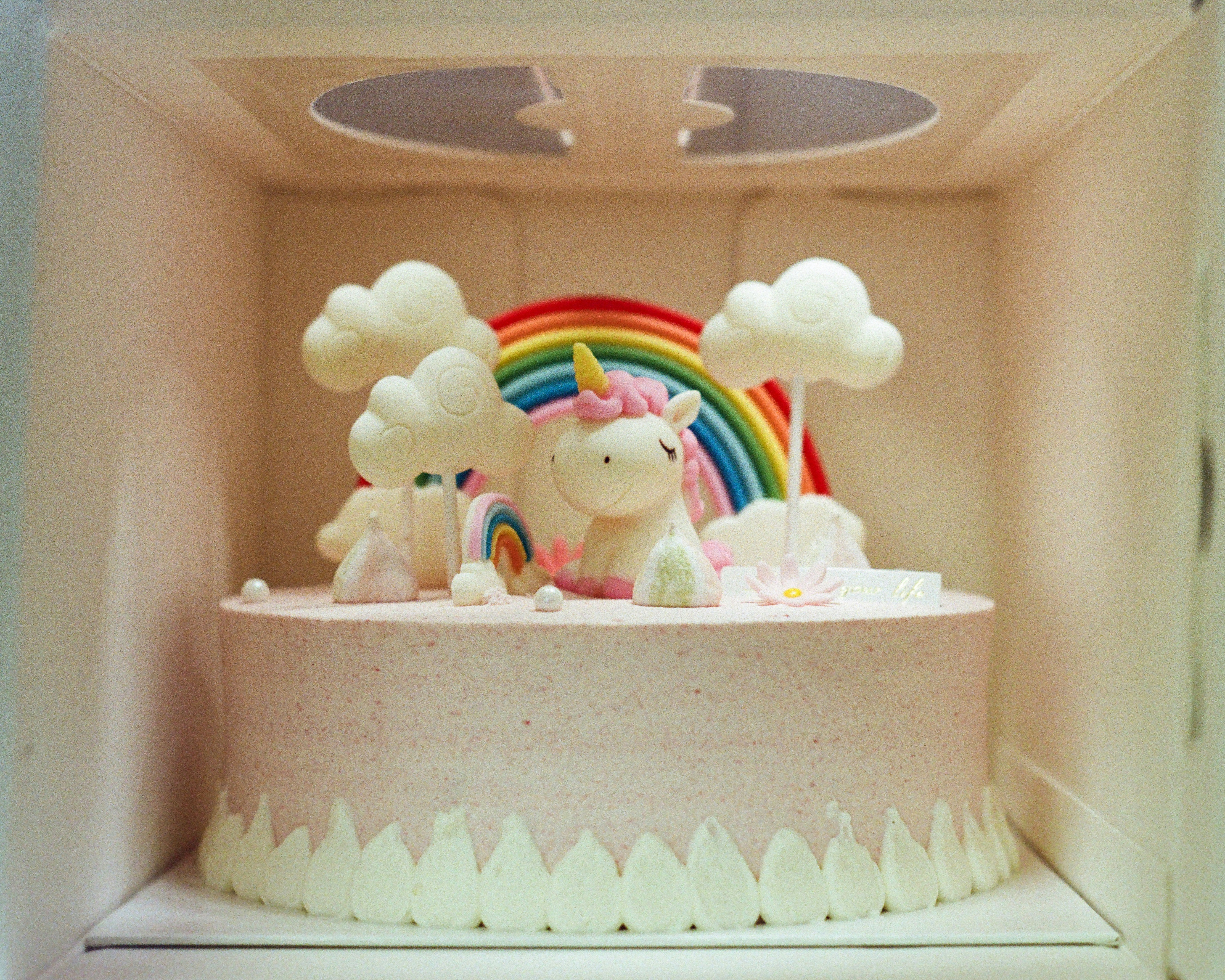 Unicorn cake with rainbow and clouds decoration