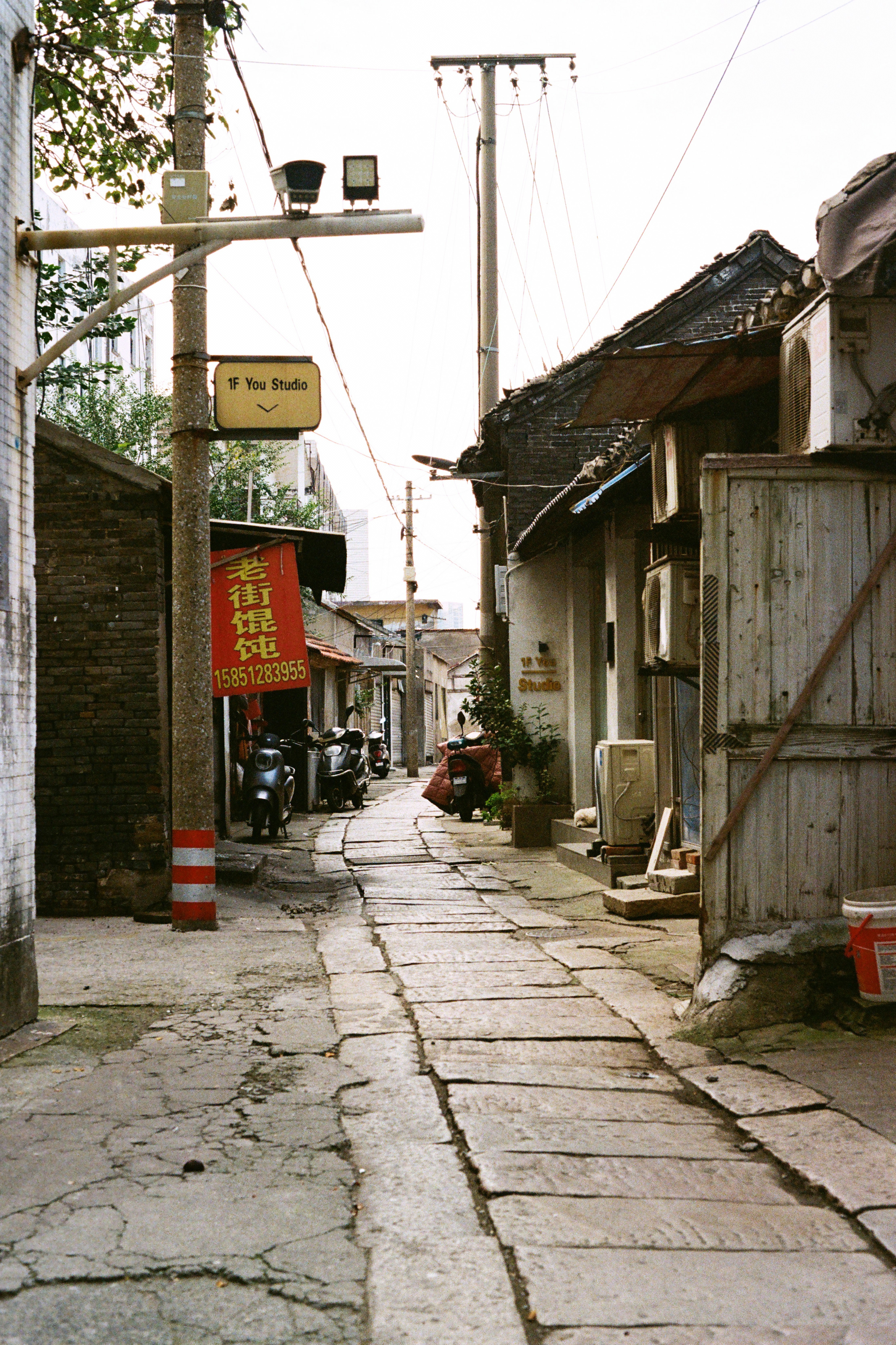 A narrow cobblestone alleyway with buildings on either side