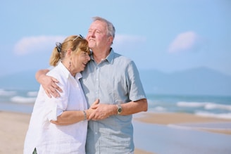 Elderly couple embracing on a sunny beach