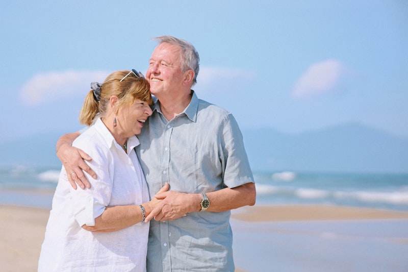 Elderly couple embracing on sunny beach