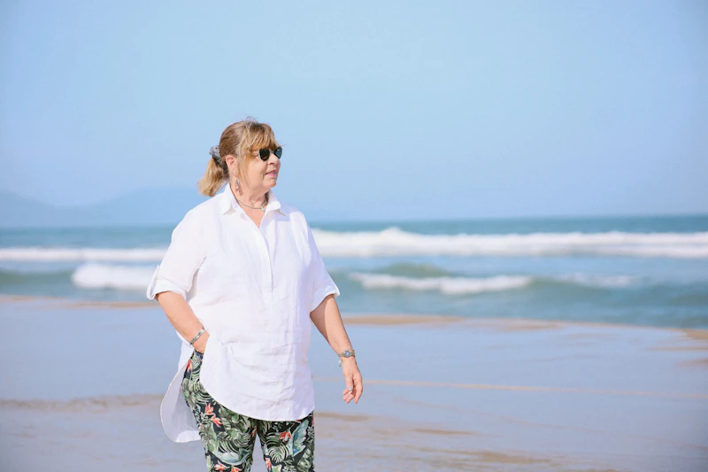 Woman walking on a sunny beach near the ocean