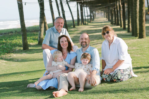Family posing for a photo on the grass