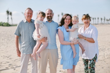 A family of five on a sandy beach