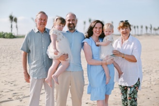 A family of five on a sandy beach