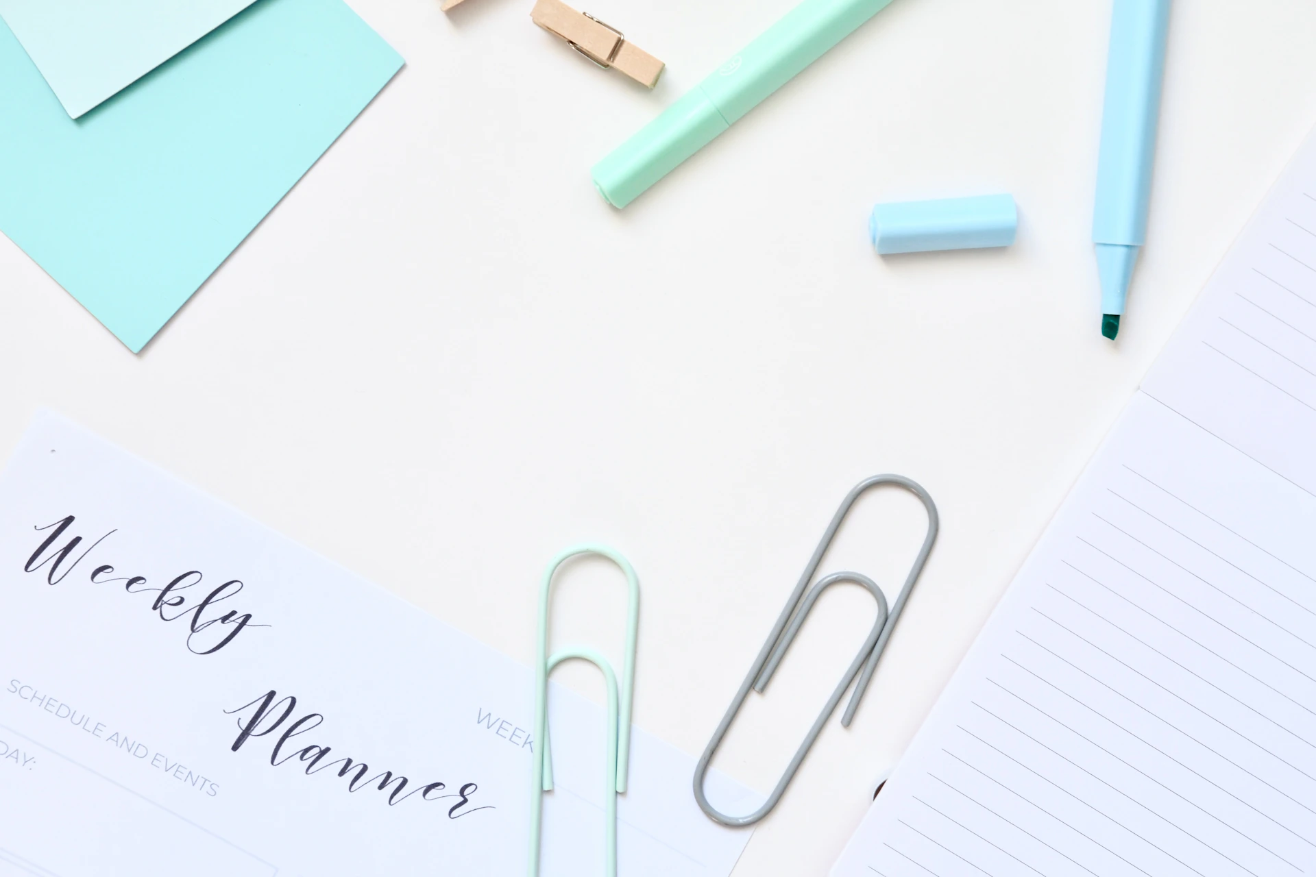 Desk supplies arranged neatly on a white surface.