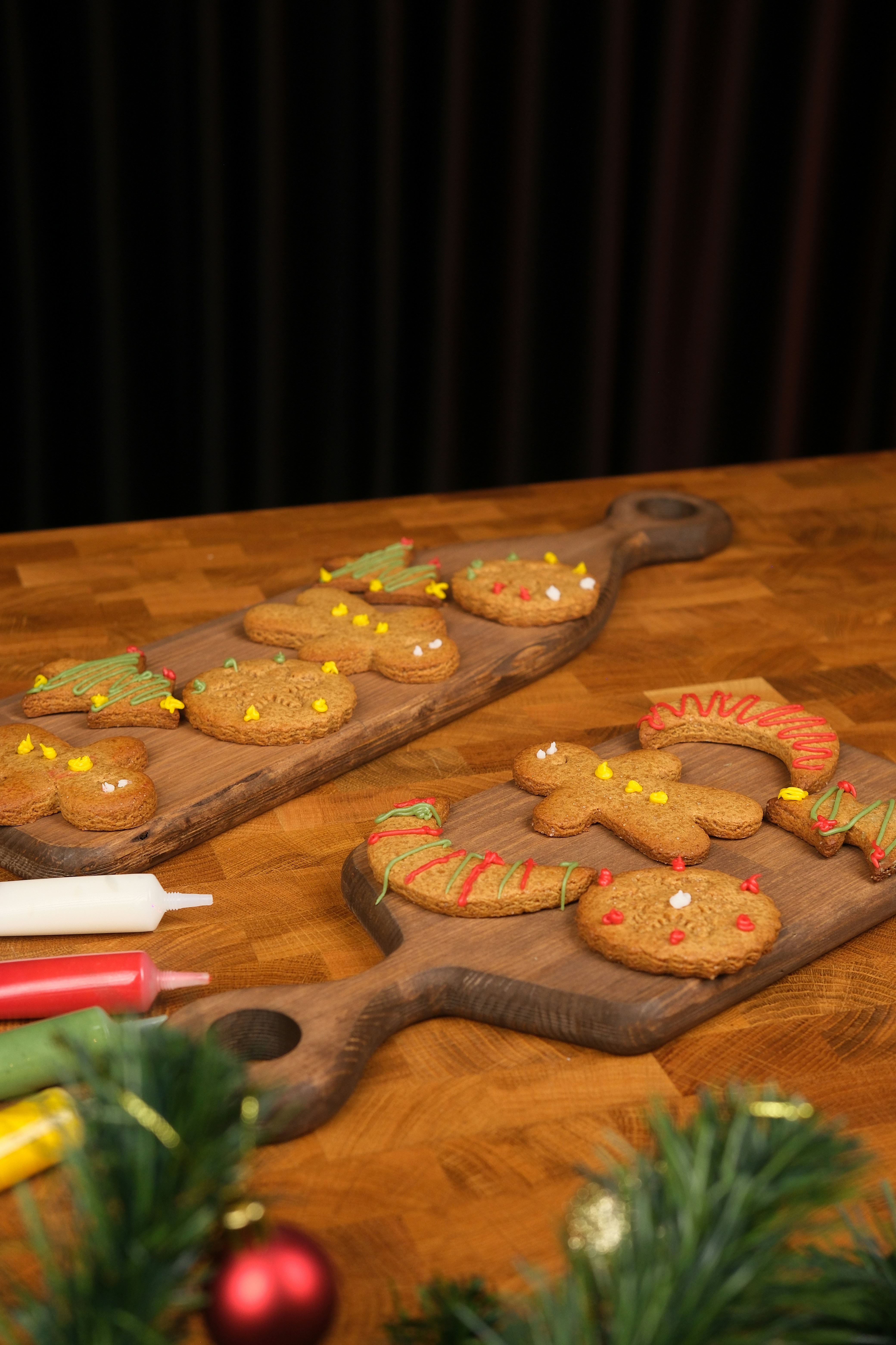 Decorated christmas gingerbread cookies on wooden boards