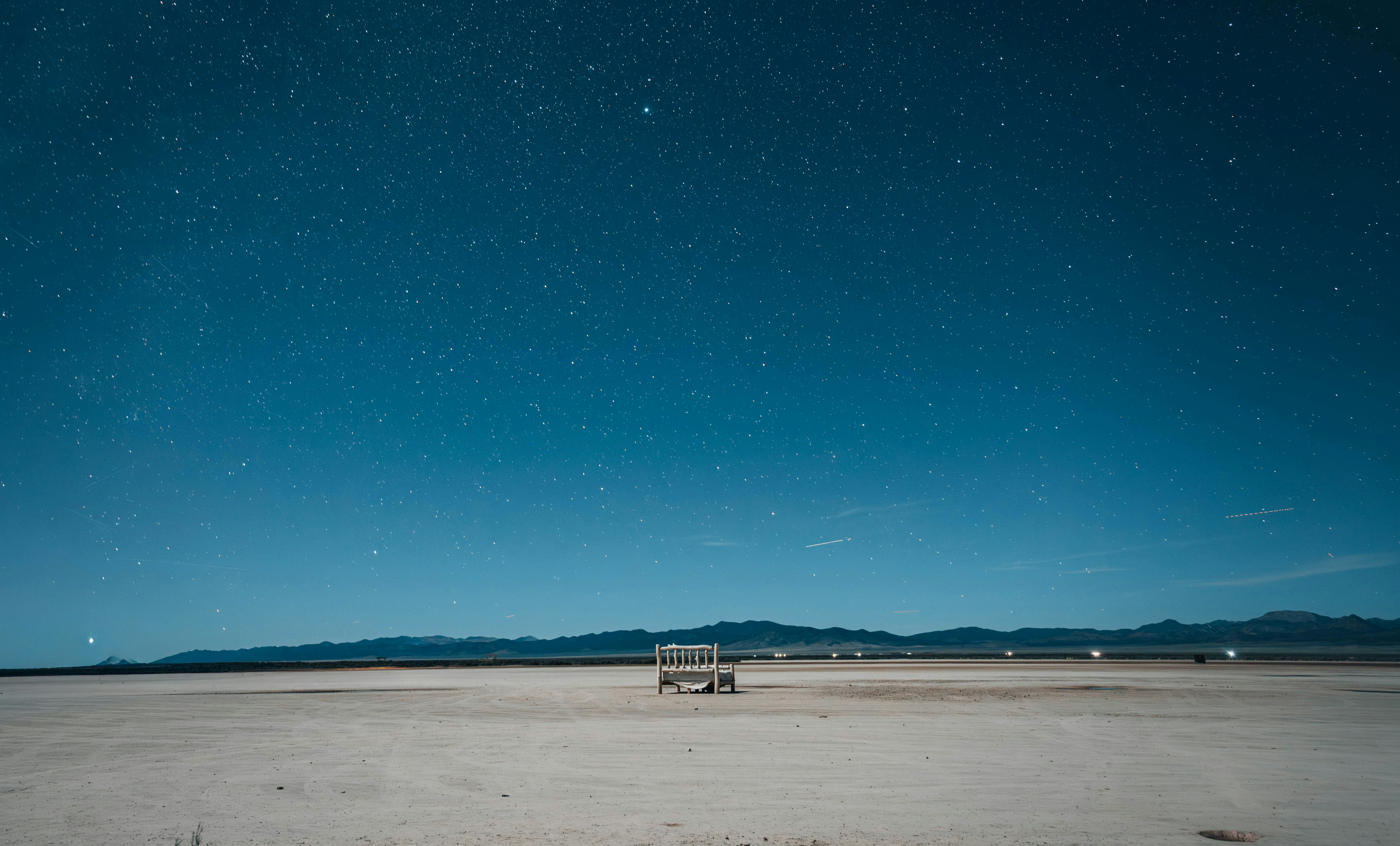 Desert landscape under a starry night sky