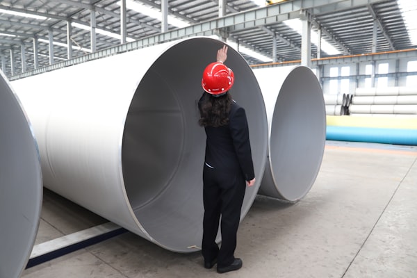 Technician inspecting pressure piping during off-site testing and certification