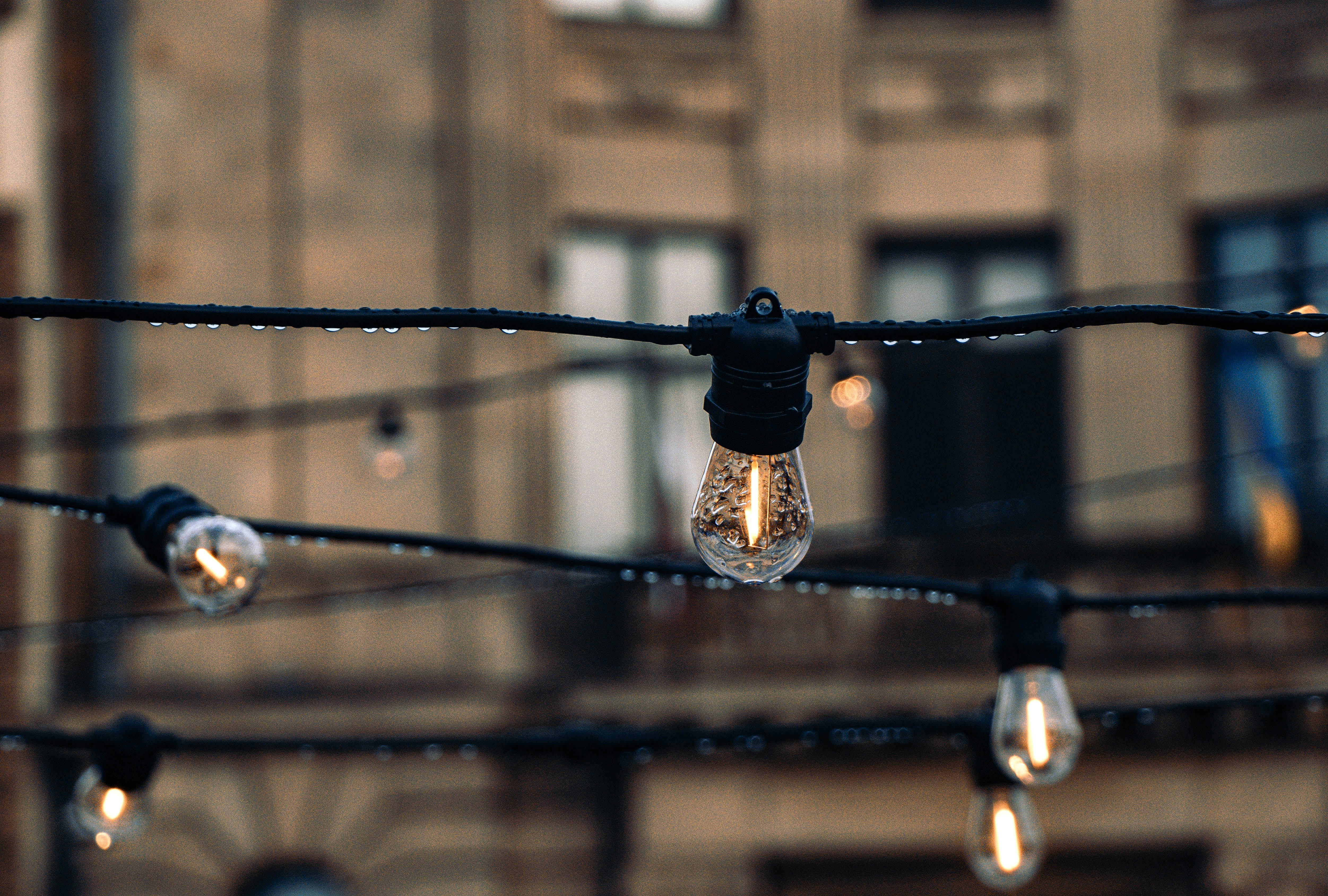 String lights with water droplets in front of building
