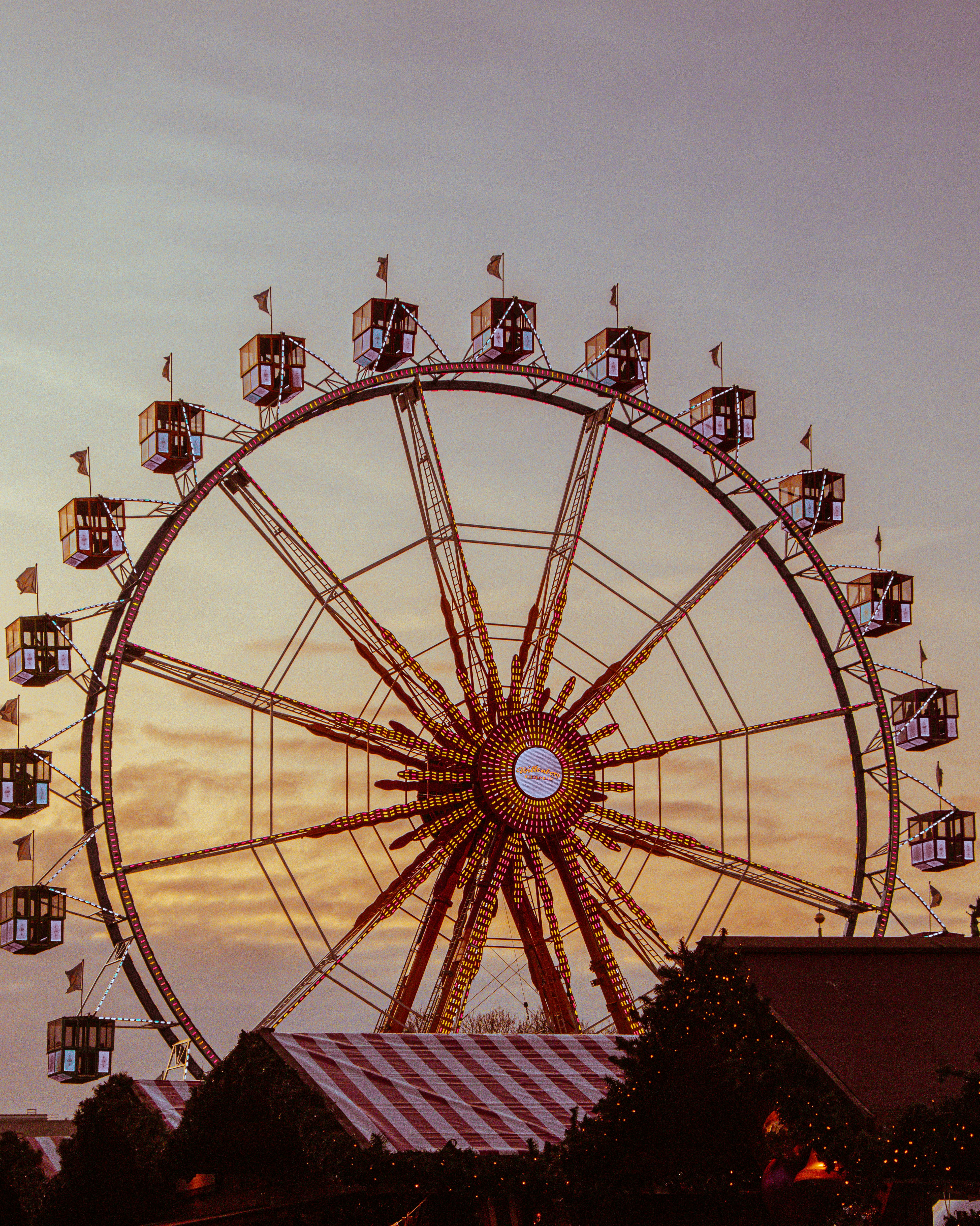 Ferris wheel at sunset with warm sky.