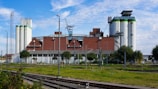 Industrial complex with silos and buildings under a blue sky