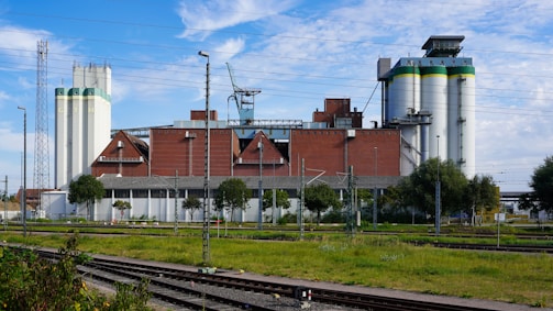 Industrial complex with silos and buildings under a blue sky