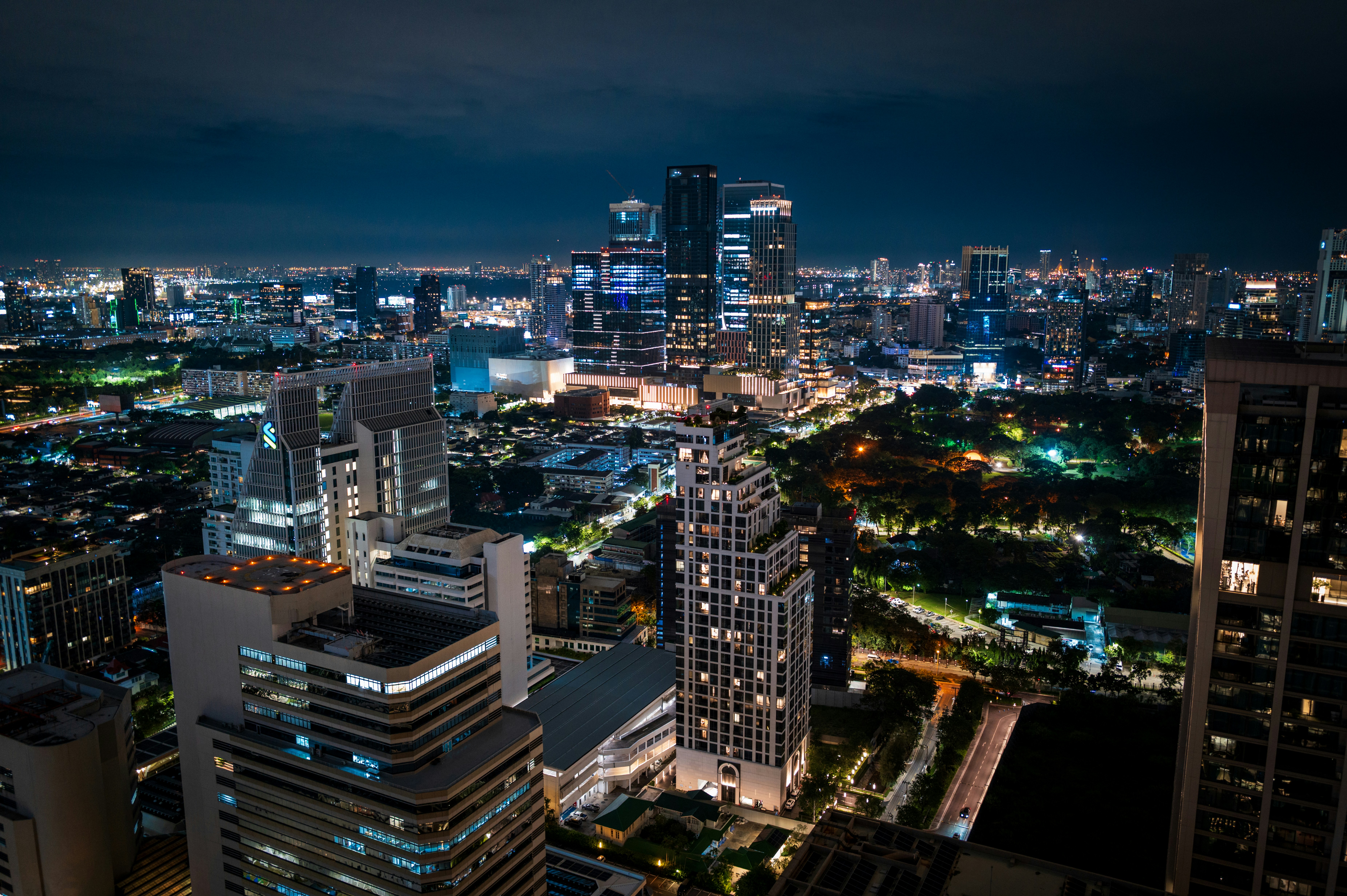Vibrant cityscape with illuminated skyscrapers at night.