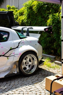White sports car with cherry blossom decals