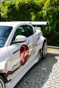 White car with japanese cherry blossom artwork.