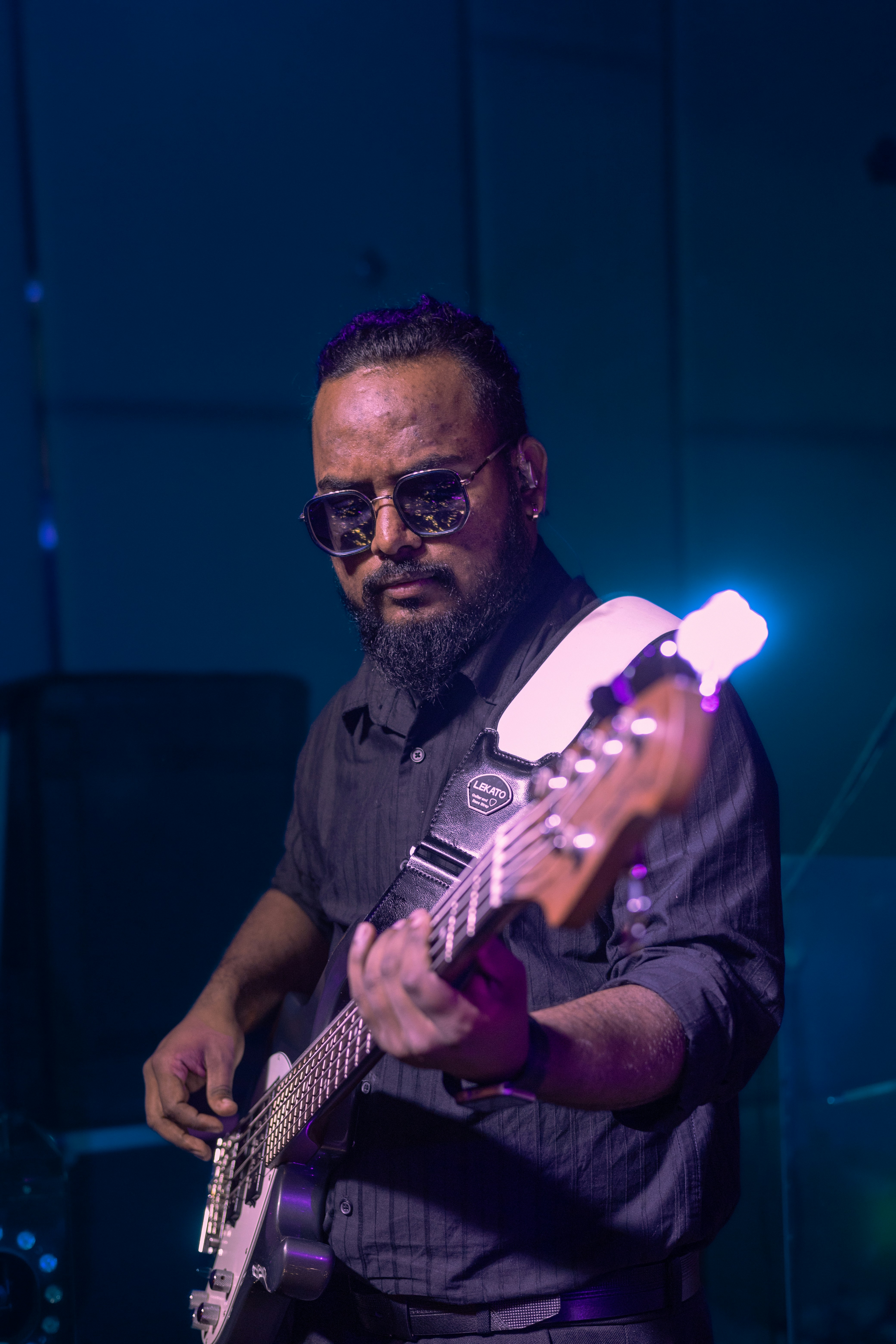 Man playing a bass guitar on stage