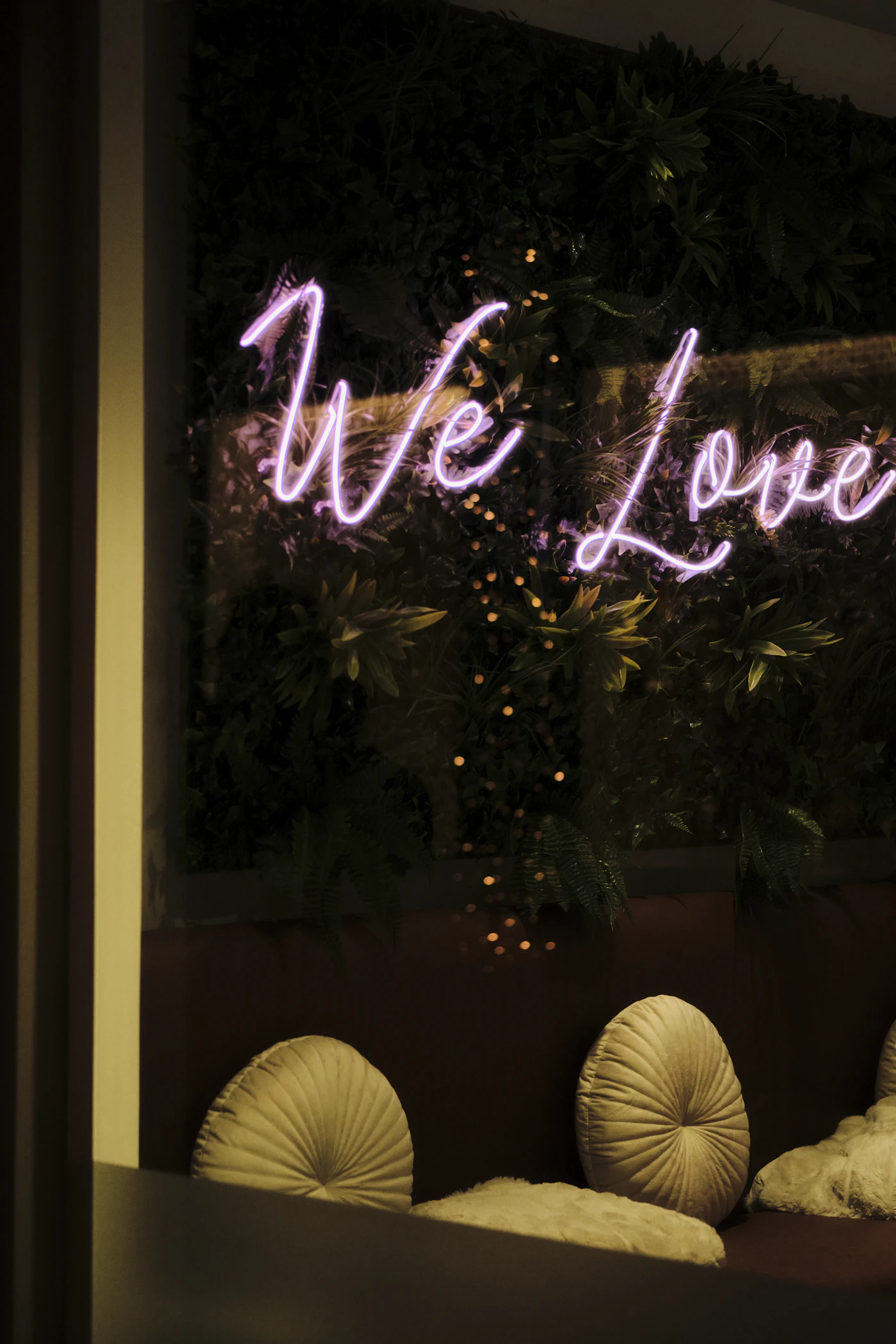 DIY neon sign installations for reception backdrops — A couple shares their first dance in front of a custom neon sign.