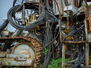 Close-up of industrial machinery with tangled wires and tracks