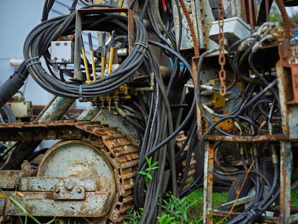 Close-up of industrial machinery with tangled wires and tracks