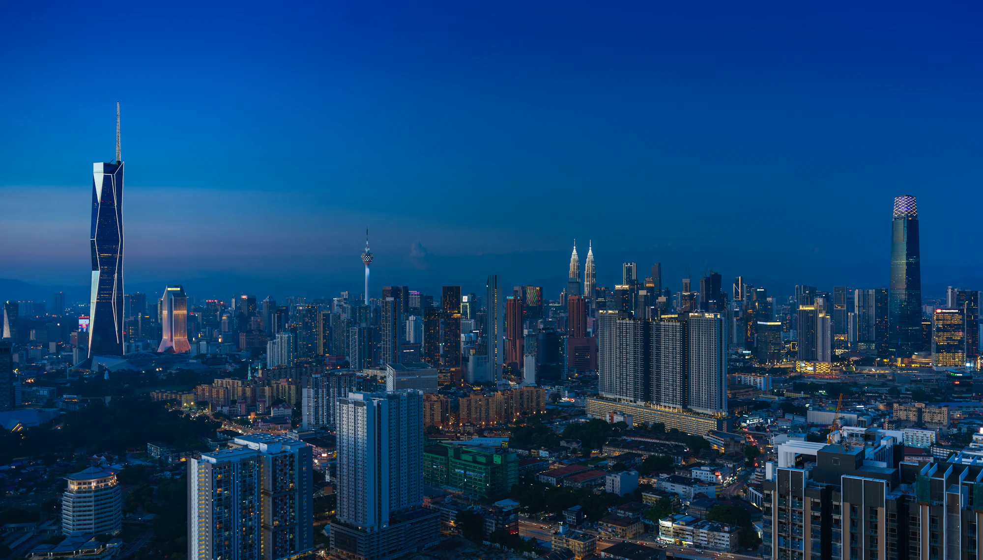 Kuala Lumpur skyline illuminated at dusk