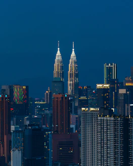 Twin towers illuminated against the night sky