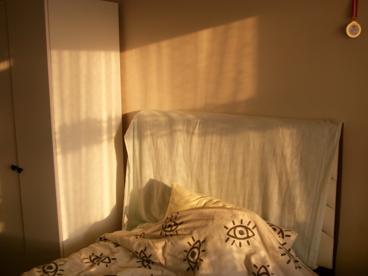 Warm sunlight streaming into a peaceful bedroom, signaling restful mornings after quitting alcohol
