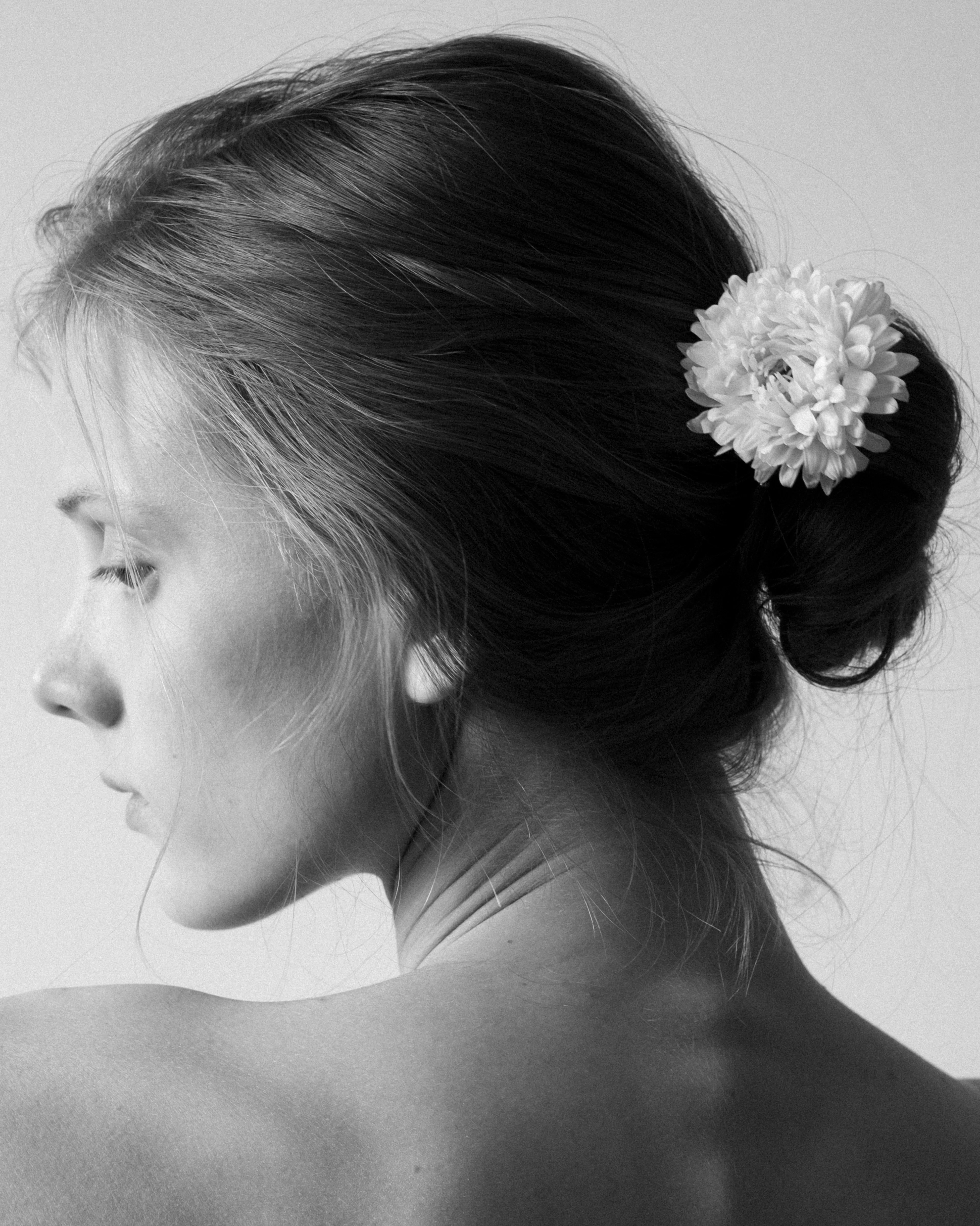 Black and white — low bun with a white flower