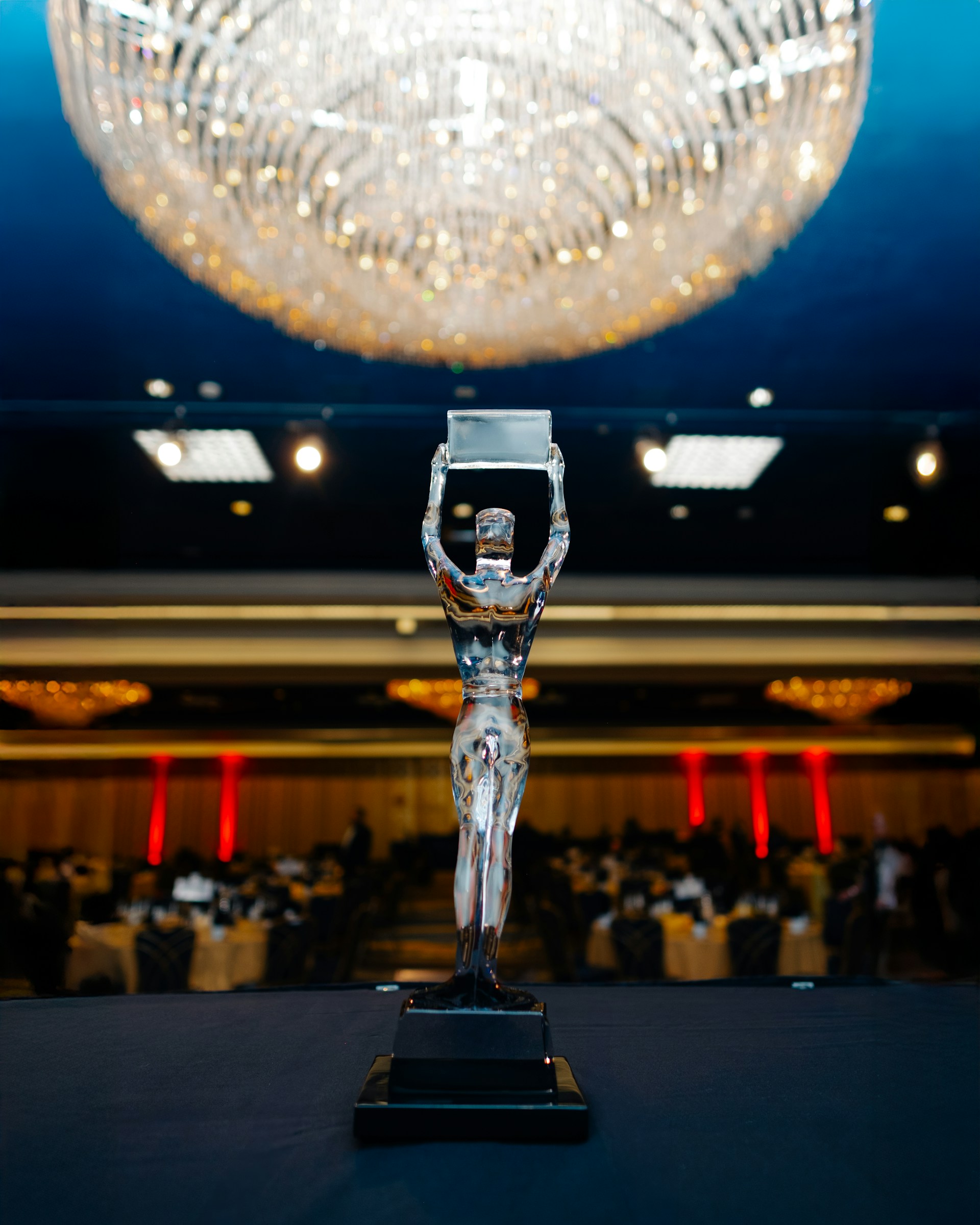 A silver award trophy stands on a table.