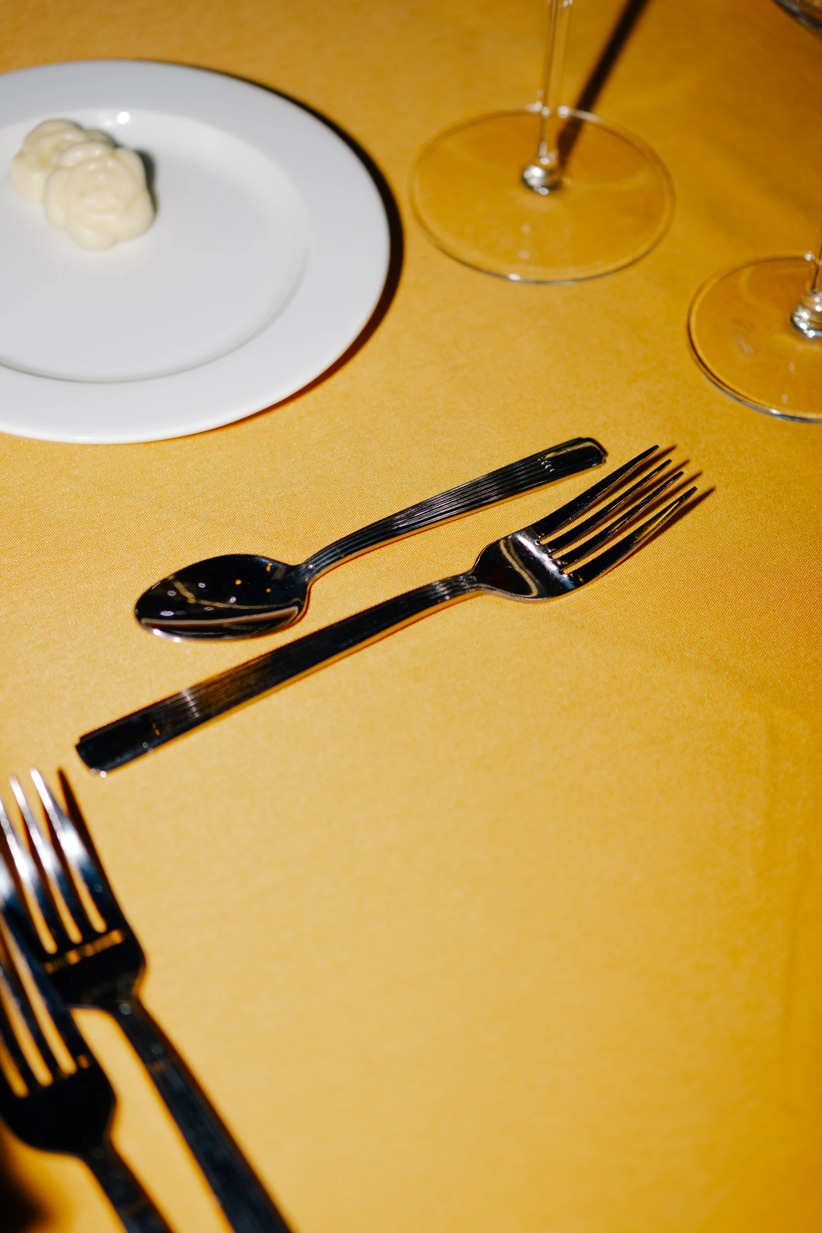 Refined table setting with dinner plate, silverware, and drinking glasses