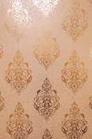 Gold ornate damask pattern on textured background