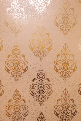 Gold ornate damask pattern on textured background