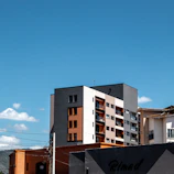 Modern buildings against a clear blue sky.
