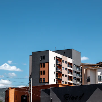 Modern buildings against a clear blue sky.
