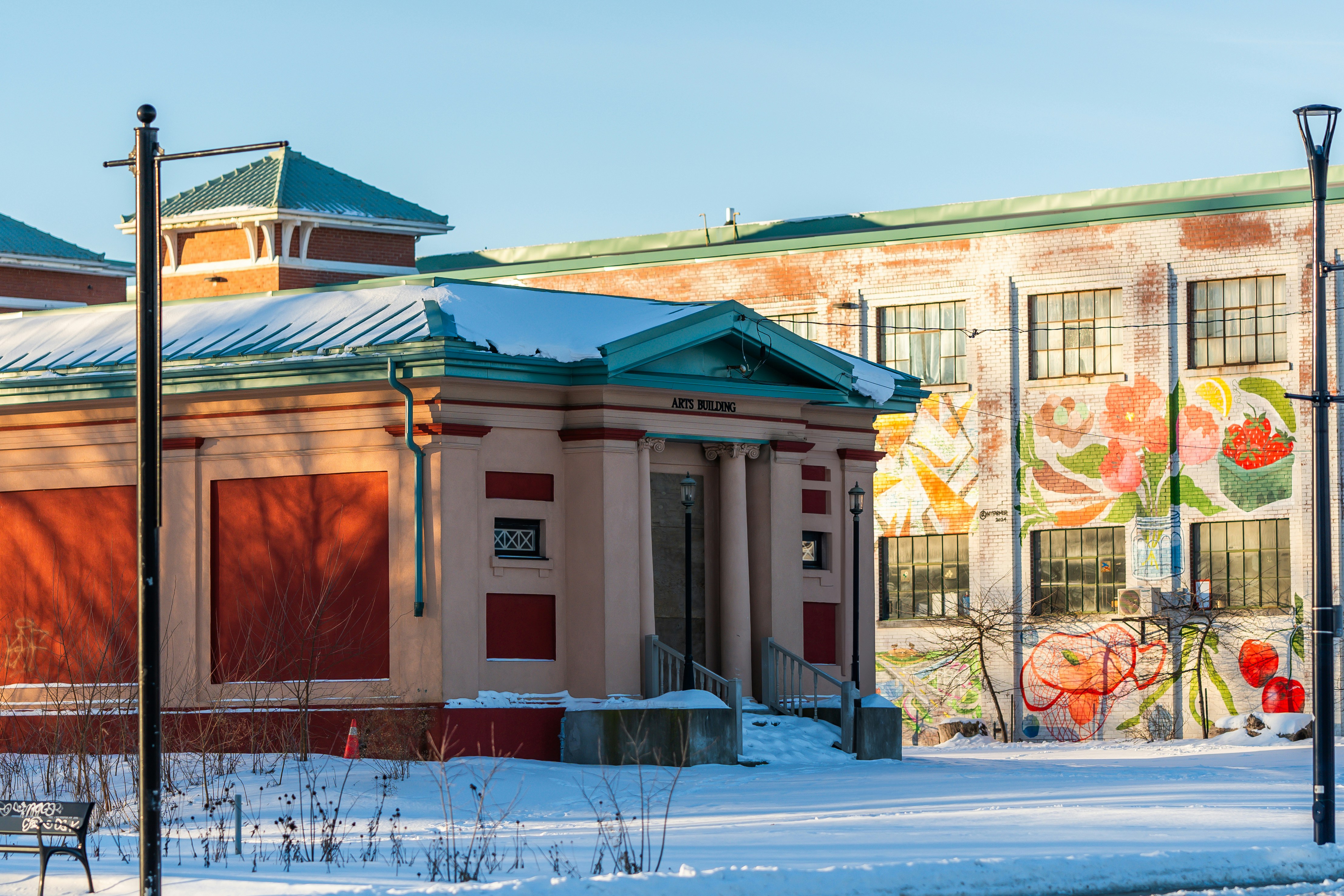 Old brick building with mural in winter snow