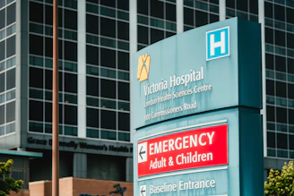 Victoria hospital emergency entrance sign with building